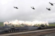 Japanese Ground Self-Defense Force armoured tanks fire during an annual training session near Mount Fuji at Higashifuji training field in Gotemba, west of Tokyo, August 19, 2014. PHOTO BY REUTERS/Yuya Shino