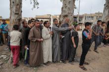 Displaced Iraqi men wait to receive humanitarian aid as the battle between the Iraqi Counter Terrorism Service and Islamic State militants continues nearby, in western Mosul, Iraq, April 23, 2017. PHOTO BY REUTERS/Marko Djurica