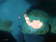 At the southernmost feature, cargo is unloaded onto the shore of Mischief Reef, located 216 km (135 miles) west of the Philippine island of Palawan, in this Center for Strategic and International Studies (CSIS) Asia Maritime Transparency Initiative satellite image, March 16, 2015. PHOTO BY REUTERS/CSIS's Asia Maritime Transparency Initiative