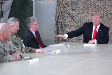 U.S. President Donald Trump, flanked by National Security Adviser John Bolton, meets political and military leaders during an unannounced visit to Al Asad Air Base, Iraq, December 26, 2018. PHOTO BY REUTERS/Jonathan Ernst