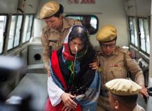 Policewomen escort Indian human rights activist Irom Sharmila as she arrives at a court in the northeastern city of Imphal, India, August 9, 2016. PHOTO BY REUTERS/Stringer