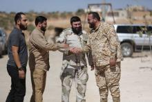 Jaish al-Islam commander Issam al-Buwaydani, shakes hands with an army commander in Jaish al-Islam in the town of Soussian in Aleppo countryside, Syria, September 23, 2018. PHOTO BY REUTERS/Khalil Ashawi