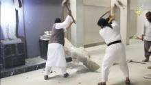 Men use sledgehammers on a toppled statue in a museum at a location said to be Mosul in this still image taken from an undated video. PHOTO BY REUTERS/Social media Web site via Reuters TV