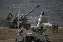 Israeli soldiers are seen next to mobile artillery units near the border with Syria in the Golan Heights January 27, 2015. PHOTO BY REUTERS/Baz Ratner