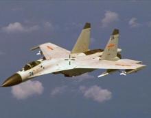 A Chinese J-11 fighter jet is seen flying near a U.S. Navy P-8 Poseidon about 215 km (135 miles) east of China's Hainan Island in this U.S. Department of Defense handout photo taken August 19, 2014. PHOTO BY REUTERS/U.S. Navy