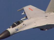 A Chinese J-11 fighter jet is seen flying near a U.S. Navy P-8 Poseidon about 215 km (135 miles) east of China's Hainan Island in this U.S. Department of Defense handout photo taken August 19, 2014. PHOTO BY REUTERS/U.S. Navy
