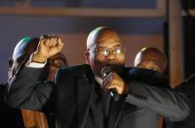 South Africa's President Jacob Zuma celebrates with his supporters after he survived a no-confidence motion in parliament in Cape Town, South Africa, August 8, 2017. PHOTO BY REUTERS/Mike Hutchings
