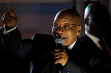 South Africa's President Jacob Zuma celebrates with his supporters after he survived a no-confidence motion in parliament in Cape Town, South Africa, August 8, 2017. PHOTO BY REUTERS/Mike Hutchings