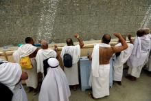 Muslim pilgrims cast stones at a pillar that symbolizes Satan, during the annual haj pilgrimage in Mena, Saudi Arabia, August 21, 2018. PHOTO BY REUTERS/Zohra Bensemra