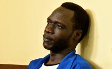 James Gatdet Dak, a former spokesman of rebel leader Riek Machar, sits inside the dock in the High Court in Juba, South Sudan, February 12, 2018. PHOTO BY REUTERS/Samir Bol