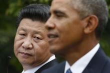 Chinese President Xi Jinping (L) listens to U.S. President Barack Obama during a joint news conference in the Rose Garden at the White House in Washington, September 25, 2015. PHOTO BY REUTERS/Kevin Lamarque