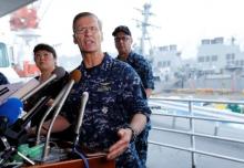 Vice Admiral Joseph Aucoin, U.S. 7th Fleet Commander, speaks to media on the status of the U.S. Navy destroyer USS Fitzgerald (seen behind him), damaged by colliding with a Philippine-flagged merchant vessel, and the seven missing Fitzgerald crew members, at the U.S. naval base in Yokosuka, south of Tokyo, Japan, June 18, 2017. PHOTO BY REUTERS/Toru Hanai