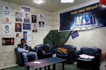 A journalist sits beside pictures of fellow journalists who have been arrested and a banner that reads "The press, It is not a crime" during a sit-in on World Press Freedom Day at the Egyptian press syndicate's headquarters in downtown Cairo, Egypt, May 3, 2016. PHOTO BY REUTERS/Amr Abdallah Dalsh