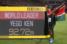 Julius Yego of Kenya poses for photographs with the result board after winning gold at the men's javelin throw final with the world leading record of 92.72 metres, during the 15th IAAF World Championships at the National Stadium in Beijing, China, August 26, 2015. PHOTO BY REUTERS/Kai Pfaffenbach