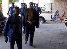 Policemen escort detained Burundi Army general Juvenal Niyungeko to a high court in Bujumbura, Burundi, May 16, 2015. PHOTO BY REUTERS/Goran Tomasevic