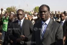 Burkina Faso President Michel Kafondo (R) and Prime Minister Isaac Zida (L) arrive at a memorial service for six people who died during the recent popular uprising in Ouagadougou, December 2, 2014. PHOTO BY REUTERS/Joe Penney