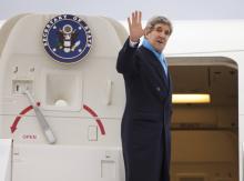 U.S. Secretary of State John Kerry waves as he boards his plane to return to the U.S., at Le Bourget Airport