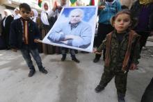 Kurdish children carry a picture of Abdullah Ocalan, jailed leader of the Kurdistan Workers' Party (PKK), during a celebration after it was reported that Kurdish forces took control of the Syrian town of Kobani, in Sheikh Maksoud neighborhood of Aleppo, January 27, 2015. PHOTO BY REUTERS/Hosam Katan