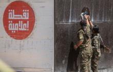 Kurdish People's Protection Units (YPG) fighters remove an Islamic State sticker in Tel Abyad town, Raqqa governorate, June 16, 2015. PHOTO BY REUTERS/Rodi Said