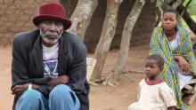 Kuzenza Magoso, 80, sits outside his third wife's home in Tanzania with some of his grandchildren, February 27, 2017. PHOTO BY REUTERS/Katy Migiro
