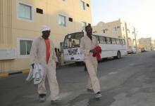 Labourers, who are working on the Qatar 2022 World Cup project, arrive at their accommodation in Doha, March 3, 2014. PHOTO BY REUTERS/Stringer