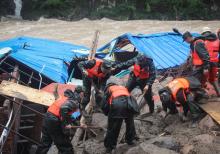 Paramilitary policemen search for missing people at the site of a landslide in Sanming, Fujian province, China, May 8, 2016. PHOTO BY REUTERS/China Daily