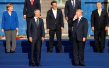 U.S. President Donald Trump, Greek Prime Minister Alexis Tsipras, Hungarian Prime Minister Viktor Orban, German Chancellor Angela Merkel and NATO Secretary General Jens Stoltenberg react as they pose for a family photo at the Park of the Cinquantenaire during the NATO Summit in Brussels, Belgium, July 11, 2018. PHOTO BY REUTERS/Kevin Lamarque