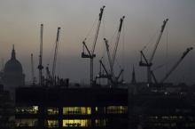 Offices are seen at dusk as St. Paul's cathedral and construction cranes are seen on the skyline in the City of London, Britain, November 2, 2015. PHOTO BY REUTERS/Toby Melville