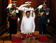 Sri Lanka's President Maithripala Sirisena (front) stands for the national anthem during a ceremony to swear in Ranil Wickremesinghe, leader of the United National Party, as Sri Lanka's new prime minister in Colombo, August 21, 2015. PHOTO BY REUTERS/Dinuka Liyanawatte
