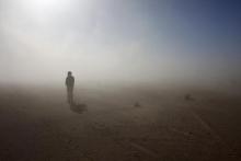 A Sahrawi man stands in the Sahara desert between Tindouf and Tifariti, February 26, 2011. PHOTO BY REUTERS/Juan Medina