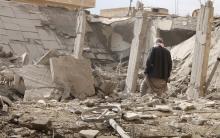 A man makes his way through rubble at a site hit by what activists said were airstrikes by forces loyal to Syria's President Bashar al-Assad in Raqqa, eastern Syria, which is controlled by the Islamic State, November 27, 2014. PHOTO BY REUTERS/Nour Fourat