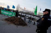 Climate change activists of Extinction Rebellion hold banners after unloading a truck filled with horse excrements in front of U.N. Climate Change Conference (COP25) in Madrid, Spain, December 14, 2019. PHOTO BY REUTERS/Nacho Doce