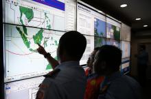 Military and rescue authorities monitor progress in the search for AirAsia Flight QZ8501 in the Mission Control Center inside the National Search and Rescue Agency in Jakarta, December 29, 2014. PHOTO BY REUTERS/Darren Whiteside