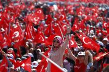 A woman reacts as she attends the Democracy and Martyrs Rally, organized by Turkish President Tayyip Erdogan and supported by ruling AK Party (AKP), oppositions Republican People's Party (CHP) and Nationalist Movement Party (MHP), in Istanbul, Turkey, August 7, 2016. PHOTO BY REUTERS/Osman Orsal