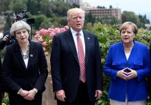 (L-R) Britain's Prime Minister Theresa May, U.S. President Donald Trump and German Chancellor Angela Merkel arrive to watch an Italian flying squadron as part of activities at the G7 Summit in Taormina, Sicily, Italy, May 26, 2017. PHOTO BY REUTERS/Stephane De Sakutin