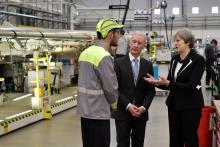 Britain's Prime Minister Theresa May speaks to workers, accompanied by Michael Ryan, president of Bombardier Aerostructures and Engineering services division, during a visit to the Bombardier factory in Belfast, Northern Ireland, February 12, 2018. PHOTO BY REUTERS/Charles McQuillan