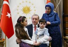 Turkish President Tayyip Erdogan, accompanied by his wife Emine Erdogan, meets with Syrian girl Bana Alabed, known as Aleppo's tweeting girl, and her family at the Presidential Palace in Ankara, Turkey, December 21, 2016. PHOTO BY REUTERS/Kayhan Ozer/Presidential Palace