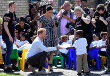 The Duke and Duchess of Sussex, Prince Harry and his wife Meghan, talk with a child during a Justice Desk initiative in Nyanga township, on the first day of their African tour in Cape Town, South Africa, September 23, 2019. PHOTO BY REUTERS/Toby Melvill