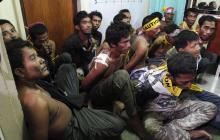 Members of the Muslim rebels of Moro National Liberation Front (MNLF), who surrendered to the government soldiers, wait to be fingerprinted at a police station in Zamboanga city
