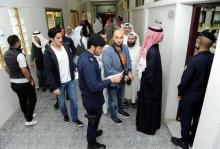 Kuwaiti men arrive to cast their votes during parliamentary election in a polling station in Kuwait City, Kuwait, November 26, 2016. PHOTO BY REUTERS/Stringer