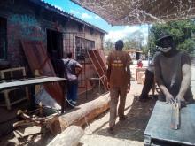 Men go about their business at a carpentry workshop in Bulawayo, Zimbabwe, March 25, 2019. PHOTO BY Thomson Reuters Foundation/Marko Phiri