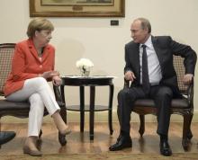 Russian President Vladimir Putin (R) meets with German Chancellor Angela Merkel in Rio de Janeiro, July 13, 2014. PHOTO BY REUTERS/Alexey Nikolsky