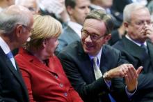 German Chancellor Angela Merkel talks to President of the German Automotive Industry Association (VDA) Matthias Wissmann (2nd R) while sitting next to Volkswagen's then-CEO Martin Winterkorn (R) during the official opening of the Frankfurt Motor Show (IAA) in Frankfurt, September 12, 2013. REUTERS/Kai Pfaffenbach