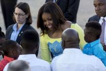 U.S. first lady Michelle Obama speaks with wellwishers at Stansted Airport, southern England, June 15, 2015. PHOTO BY REUTERS/Neil Hall