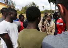 Adolescent migrants argue during a protest in a courtyard at an immigration centre in Caltagirone, Sicily, March 18, 2015. PHOTO BY REUTERS/Alessandro Bianchi
