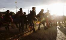 Migrants are on their way to Austria at the railway station at the border crossing with Austria in Hegyeshalom, Hungary, September 27, 2015. PHOTO BY REUTERS/Heinz-Peter Bader