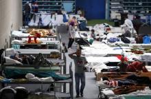 Migrants rest at an temporary shelter in a sports hall in Hanau, Germany, September 29, 2015. PHOTO BY REUTERS/Kai Pfaffenbach