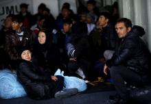 Refugees and migrants board Turkish Coast Guard Search and Rescue ship Umut-703 after a failed attempt of crossing to the Greek island of Lesbos off the shores of Canakkale, Turkey, November 8, 2015. PHOTO BY REUTERS/Umit Bektas