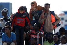 Migrants wait to disembark from the Italian coastguard vessel Peluso in the Sicilian harbour of Augusta, Italy, May 13, 2016. PHOTO BY REUTERS/Antonio Parrinello