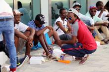 Migrants workers have food during a celebratory event before the final soccer match between Taleb Group and Gulf Contracting at Qatar Workers Cup in Doha, Qatar, May 6, 2016. PHOTO BY REUTERS/Stringer